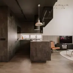 Nowoczesna kuchnia i salon w stylu eco brutalism. Betonowe powierzchnie, ciemne akcenty i minimalistyczne meble tworzą surowy, ale przytulny klimat.