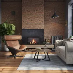 Przytulny salon w stylu soft loft z ceglaną ścianą, kominkiem, wygodnym fotelem i sofą.