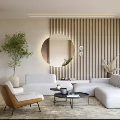 Okrągłe lustro z podświetleniem nad kanapą to idealne rozwiązanie, gdzie powiesić lustro w salonie. Dodaje elegancji i optycznie powiększa przestrzeń.